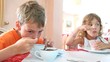 Boy and girl eat granola and yogurt for breakfast