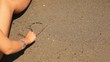 Hand writes the word sea in the sand