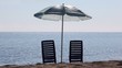 Video: Two empty deckchairs stand on beach under parasol Two empty deckchairs stand on beach under parasol