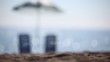 Video: Two empty deckchairs stand on beach under parasol Two empty deckchairs stand on beach under parasol