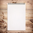 White notebook for painting on wooden background White notebook for painting on wooden background