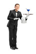 Butler with bow tie carrying a tray with a cocktail on it