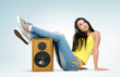 Young beautiful girl in headphones with speaker Young beautiful girl in headphones with speaker