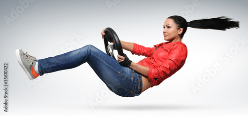 Foto: Girl driver in leather jacket with a steering wheel Girl driver in leather jacket with a steering wheel