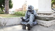 Busker earns living sitting on sidewalk