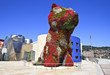 Flower dog from Bilbao with modern art museum in the background