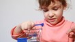 Beautiful girl play with little shopping trolley model
