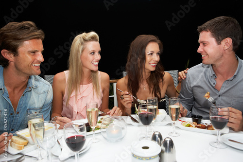 Photo: Two young couples in restaurant Two young couples in restaurant