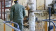 Man working in a factory, controling devices