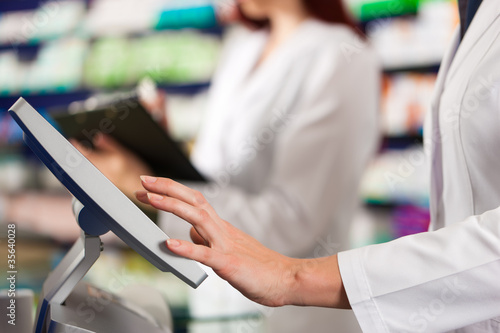 Photo: Pharmacist with assistant in pharmacy Pharmacist with assistant in pharmacy