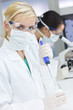 Female Scientist Doctors, Pipette & Microscope in a Laboratory