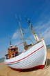 A photo of a Danish fishing boat at the beach