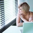 Portrait of a young woman pensively looking out of the window