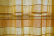 Sunlight through yellow and orange curtain