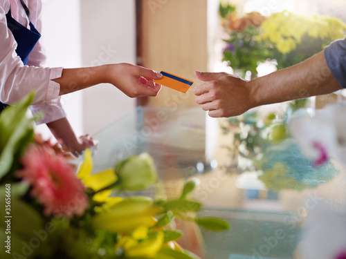 Photo: client with credit card shopping in flowers shop client with credit card shopping in flowers shop