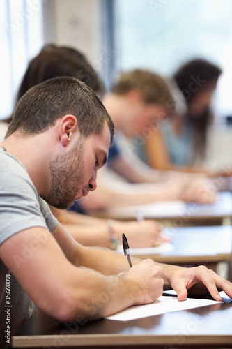 Photo: Portrait of a young man writing Portrait of a young man writing