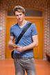 Portrait of a handsome student with a tablet computer