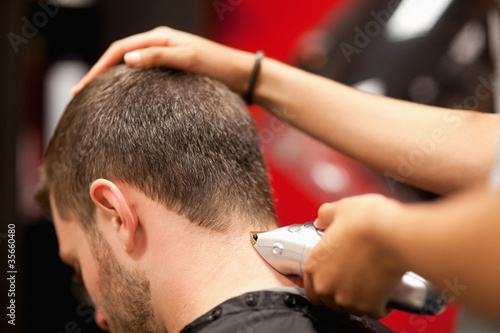 Photo: Close up of a male student having a haircut Close up of a male student having a haircut