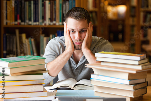 Photo: Depressed student having a lot to read Depressed student having a lot to read