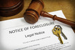 Foreclosure document with house keys and gavel