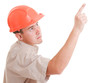 Businessman in helmet pointing up.