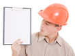 Businessman in helmet holding a tablet.