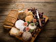 cheeseboard with an assortment of cheeses bread and fruits cheeseboard with an assortment of cheeses bread and fruits