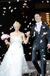 Just married couple under a rain of rose petals Just married couple under a rain of rose petals