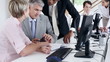 Mature male leader with multi ethnic team planning schedule