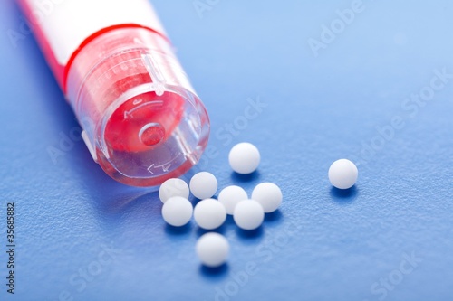Photo: Modern homeopathic pills and container Modern homeopathic pills and container