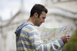 A mid-adult man  looking at a map