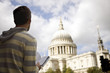 A man standing in front of St Paul's cathedral