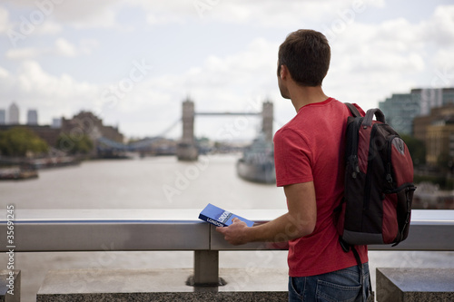Photo: A man looking down the river Thames towards Tower Bridge A man looking down the river Thames towards Tower Bridge
