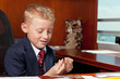 Photo: Cute boy in business attire in an office Cute boy in business attire in an office