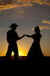 Cowboy couple silhouette hold hands Cowboy couple silhouette hold hands