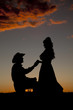 Photo: Cowboy couple silhouette him kneel Cowboy couple silhouette him kneel