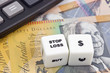 Australian currency with calculator and dice showing STOP LOSS