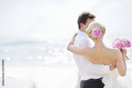 Photo: Bride and groom by the sea Bride and groom by the sea