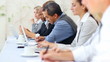 Executives busy working during seminar