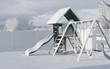 A playground covered in freshly fallen snow