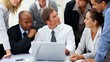 Multi racial business people working on laptop