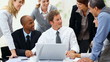 Business man speaking in meeting with multi racial colleagues