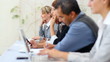Executives busy working during seminar