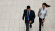 Male and female executives taking stroll together