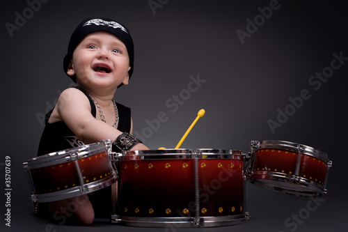 Photo: dark portrait of Beautiful boy playing the drums dark portrait of Beautiful boy playing the drums