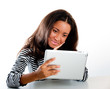 Foto: Mixed race teen girl, looking at tablet computer Mixed race teen girl, looking at tablet computer
