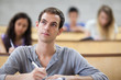 Students taking notes in an amphitheater