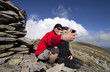 Hiker couple taking pictures up in the mountains Hiker couple taking pictures up in the mountains