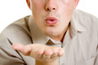 A man sends a air kiss.