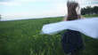 Girl running through a green field